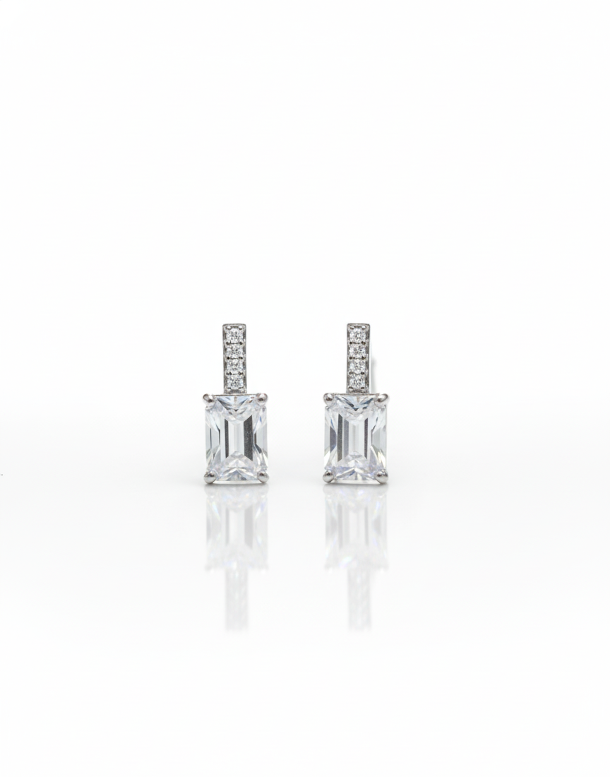 The Solitaire Cascade: Emerald Cut Silver Dangle Earrings