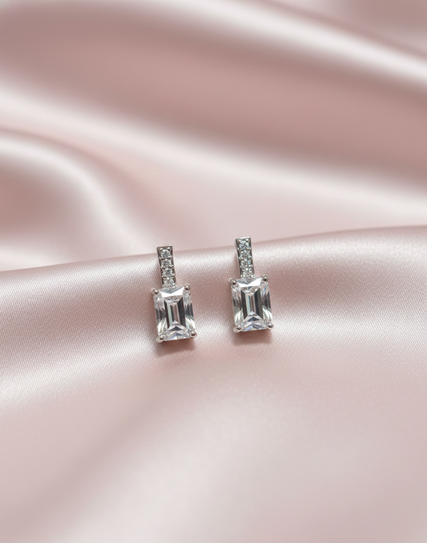 The Solitaire Cascade: Emerald Cut Silver Dangle Earrings