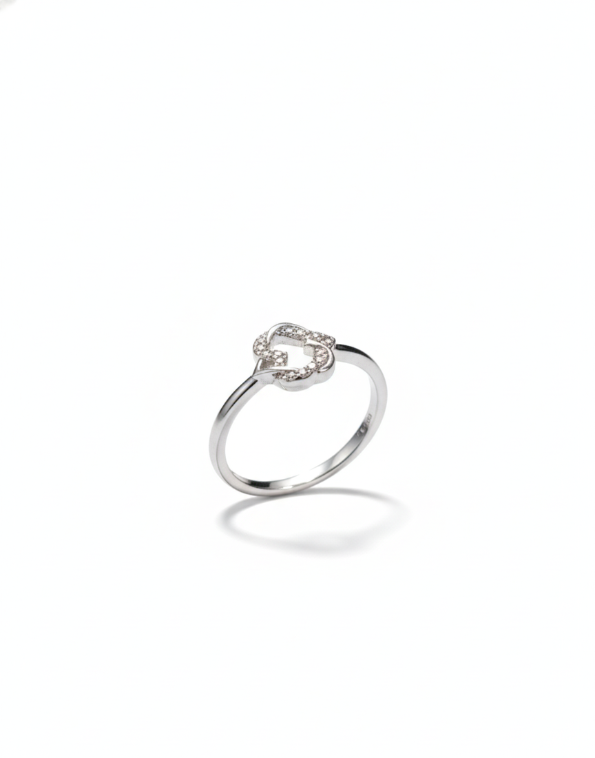 Silver ring with a heart-shaped diamond on a white background