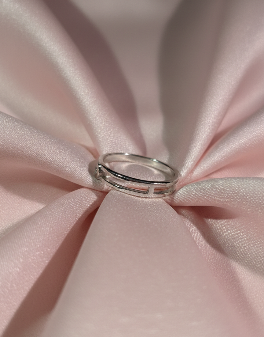 Silver ring on a pink satin fabric